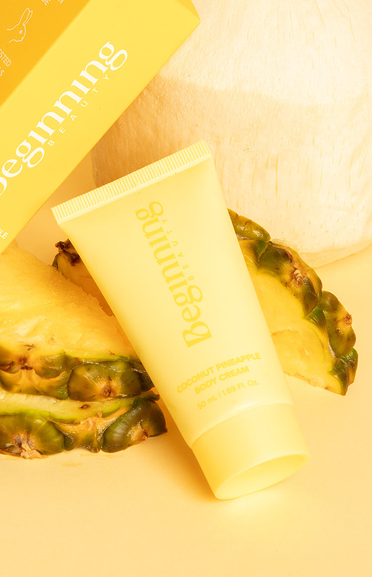 Angled yellow matte squeeze tube of body cream with ribbed cap and text label