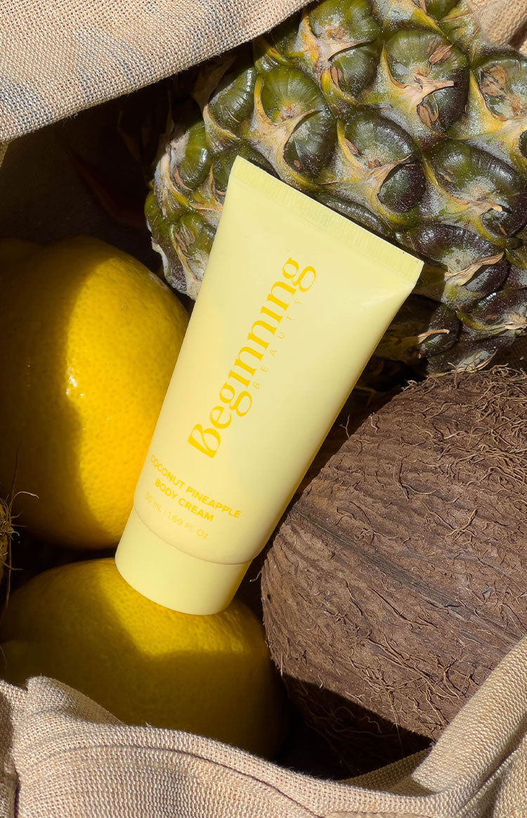 Pale yellow squeeze tube of Coconut Pineapple Body Cream 50ml, tropical