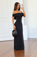 Side view of a black mesh maxi dress with white polka dots, off-shoulder ruched neckline, and short sleeves