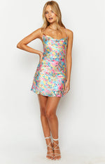 Front view of a pink floral satin mini dress featuring a draped cowl neck and delicate spaghetti straps