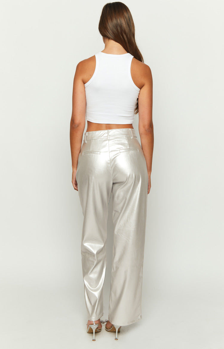 Close-up of the metallic silver pants showing the side pocket, waistband, and button closure