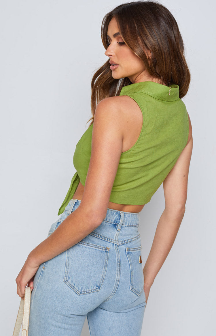 Close-up of the olive green tie-up shirt showing the front knot detail and open collar