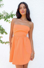 Orange strapless mini dress with a fitted bodice, side cutouts, and a flared gathered skirt