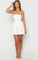 Beginning Boutique Cora White Tie Back Mini Dress white strapless mini dress with a large back tie and waist cutouts