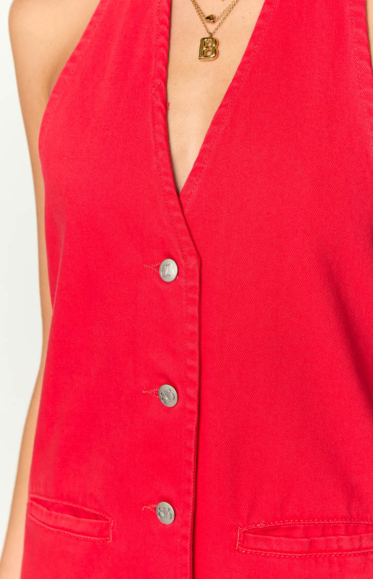 Close-up of the red denim mini dress showing silver buttons and small front pockets