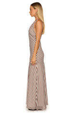 Side view of a brown and white stripe maxi dress with diagonal stripes on the bodice and vertical stripes on the flowy skirt with a side slit