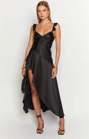 girl wearing a black maxi dress and gold necklace