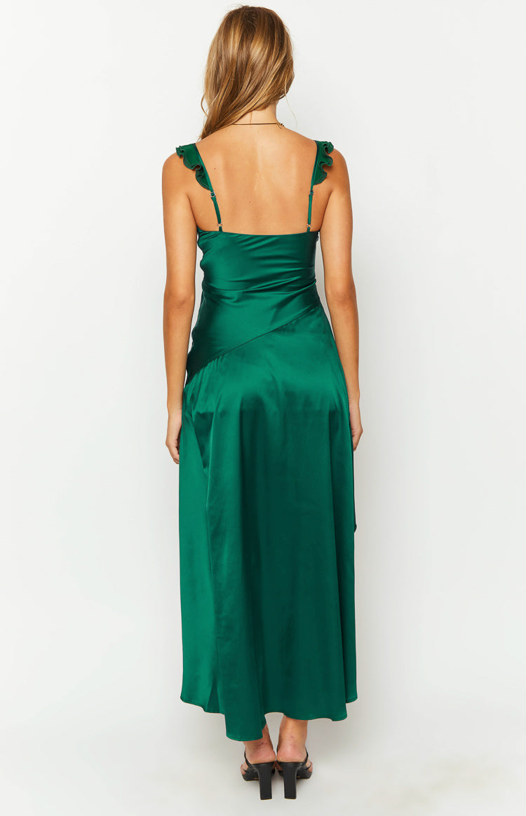 Side view of an emerald green satin maxi dress with a V-neck, ruffled straps, and an asymmetrical high-low skirt with a high slit