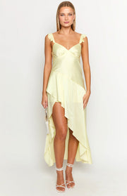Pale yellow maxi dress with a sweetheart neckline, ruffled shoulder straps, and an asymmetrical high-low hem
