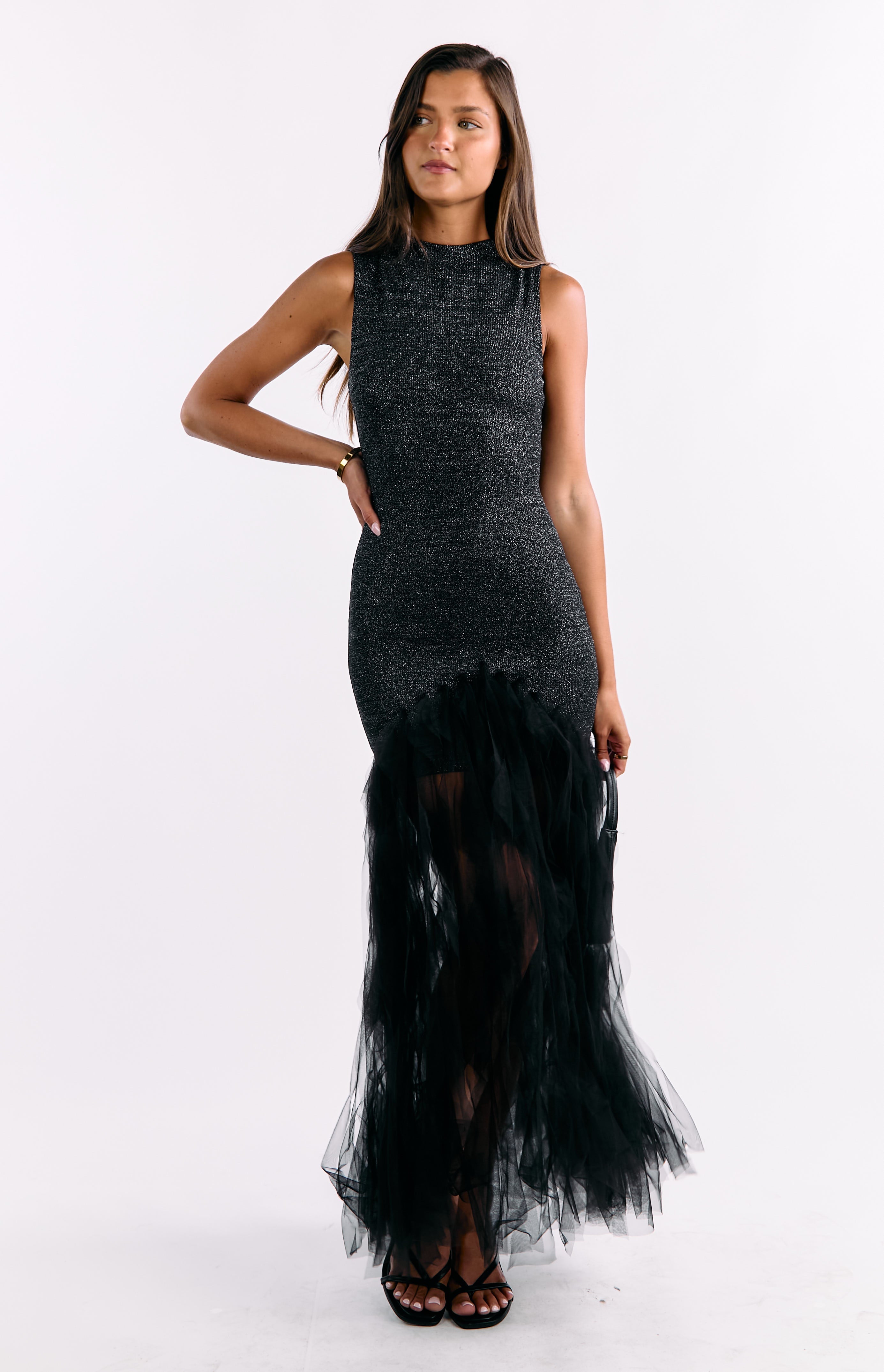 Front view of a black maxi dress with a shimmering fitted sleeveless bodice and a voluminous ruffled tulle skirt