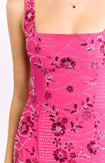 Close-up of the hot pink mini dress showing the square neckline and intricate beaded and sequin floral pattern