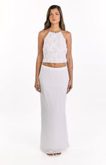 Front view of a white textured halter top with a floral ruched pattern and a cropped hem