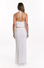 Rear view of the white textured halter top showing the tie-back halter straps and cropped hem