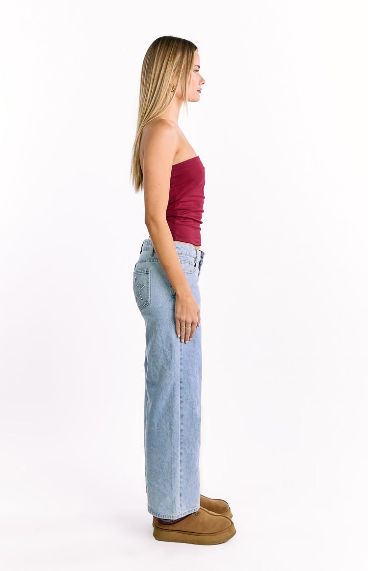 Side view of a fitted burgundy strapless top with a straight neckline ending at the waist