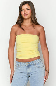 Yellow strapless tube top with a fitted, cropped silhouette and soft gathered fabric