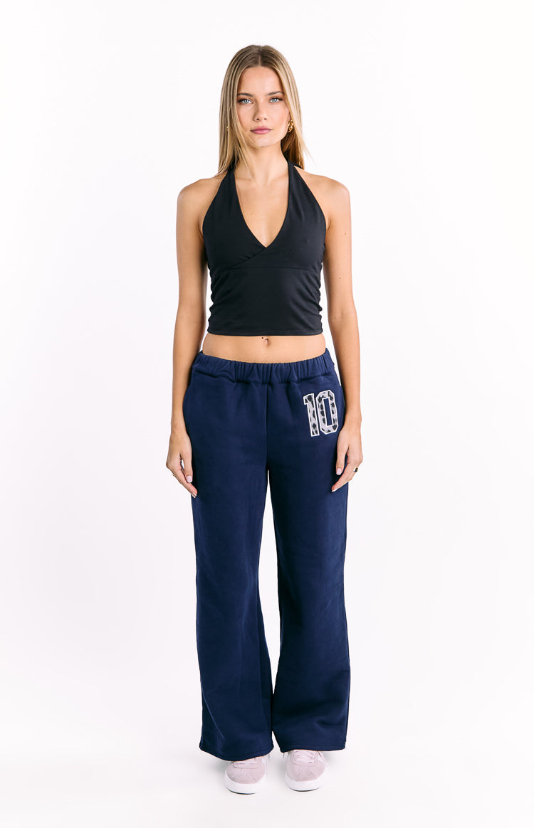 Navy wide-leg track pants with an elasticated waist and a white '10' graphic featuring leopard print stars