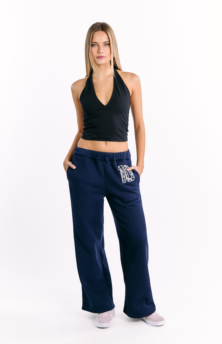 Navy track pants with elasticated waist, side pockets, and a white leopard print '16' graphic on the left thigh