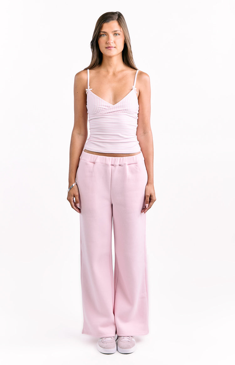 Light pink wide-leg track pants with a relaxed fit and elastic waistband