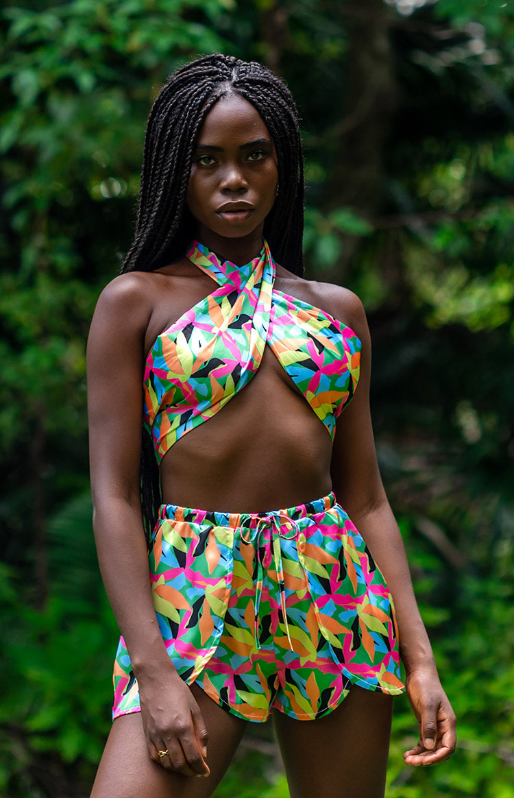 Gathered elasticated waistband with a tied drawstring on vibrant tropical leaf print satin shorts