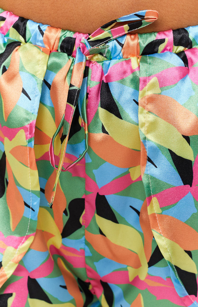 Bright tropical leaf print two-piece set with a criss-cross halter crop top and wrap shorts