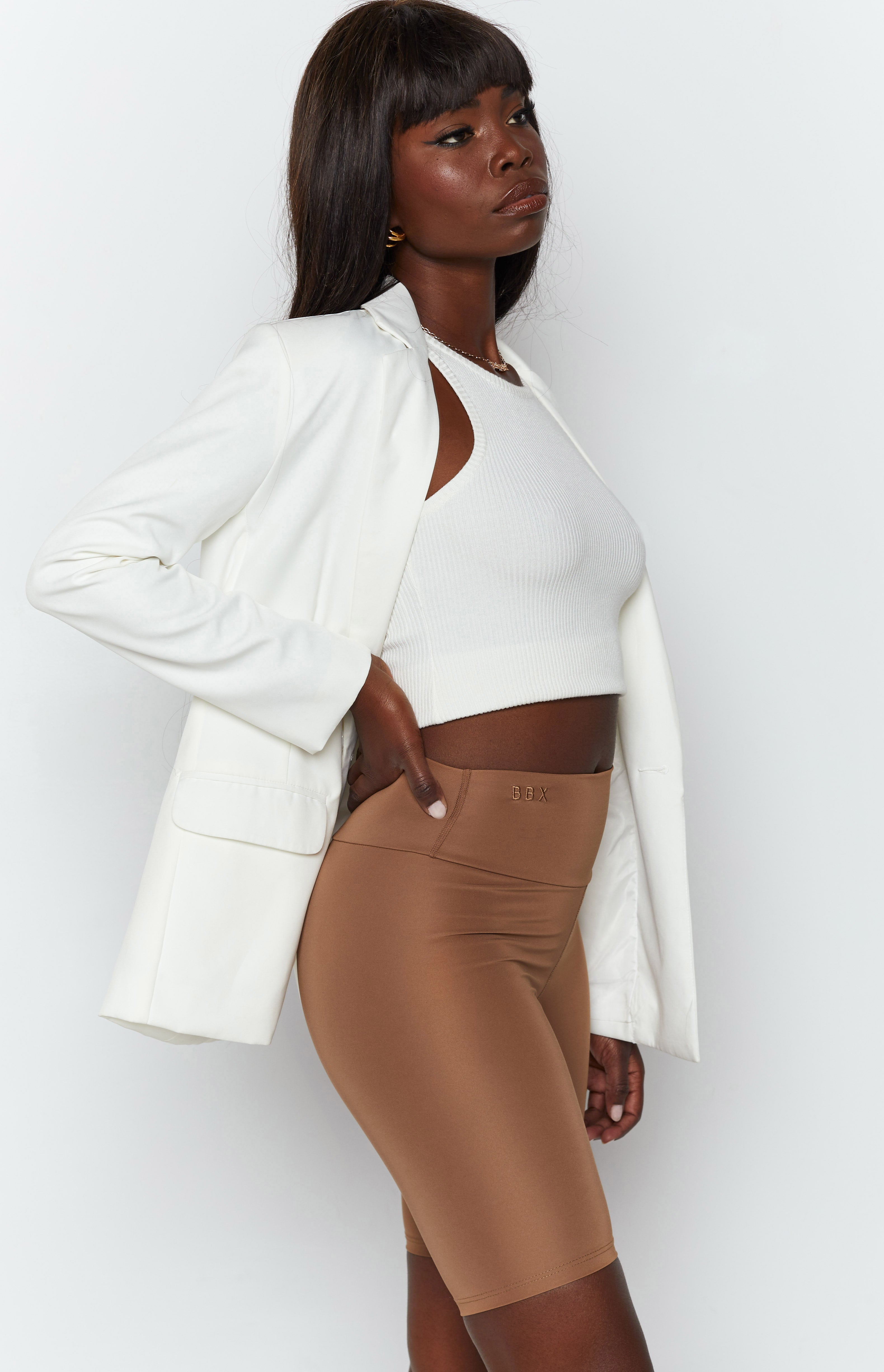 Toffee high-waisted bike shorts with a smooth, stretchy fabric and visible seam details on the back
