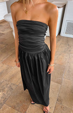 Black strapless maxi dress with a ruched bodice, a defined waist band, and a flowing gathered skirt