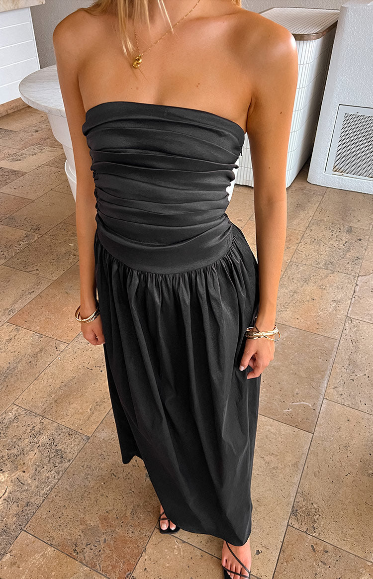 Black strapless maxi dress with a ruched bodice, a defined waist band, and a flowing gathered skirt