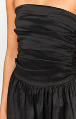 Black textured strapless bodice with horizontal ruching and a gathered waist on the dress