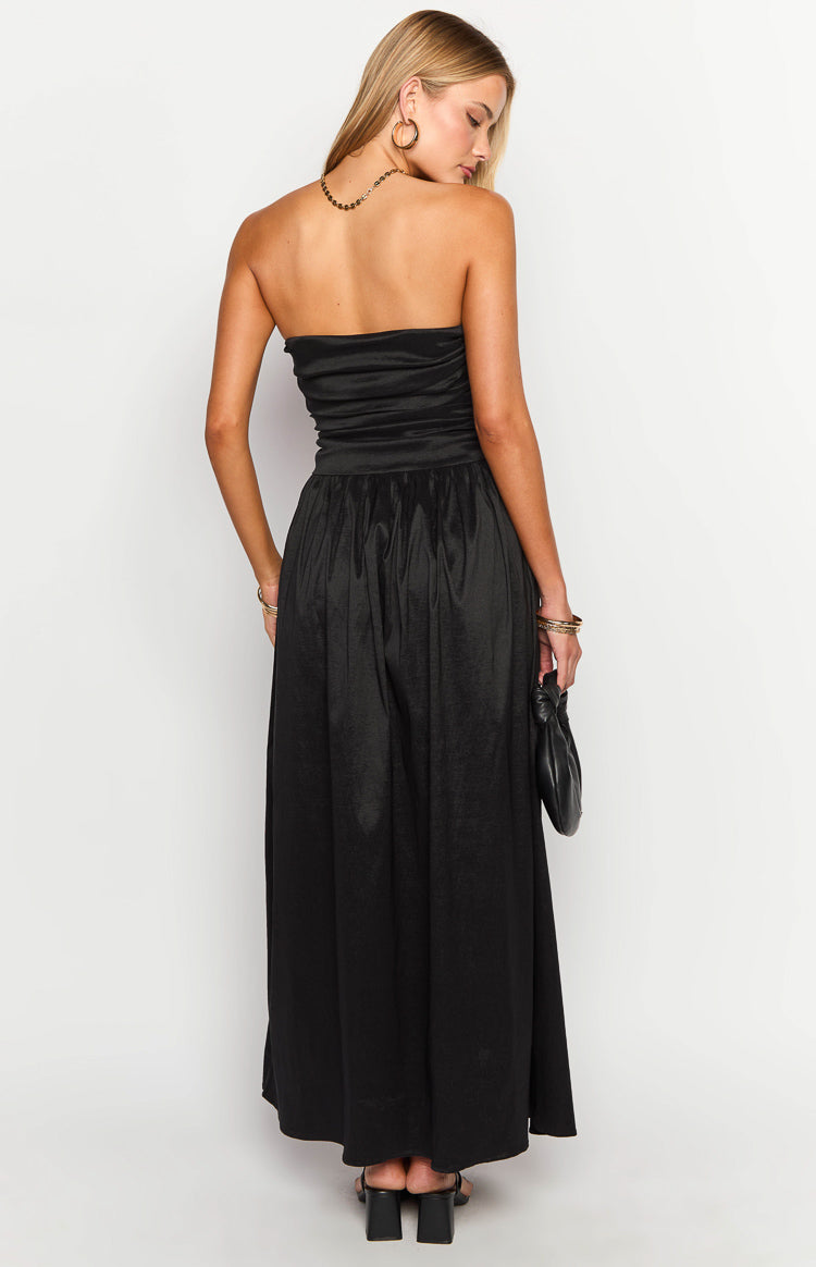 Rear view of a black strapless maxi dress with a ruched bodice and a flowy maxi skirt