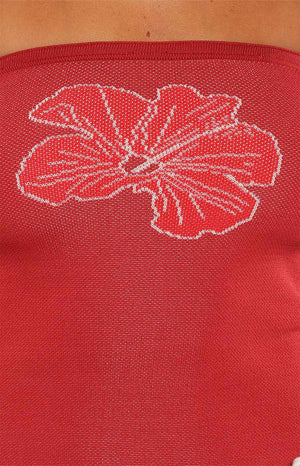 Model in the Deja Red Knit Hibiscus Tube Top a strapless top perfect for a summer festival outfit or a tropical vacation look.