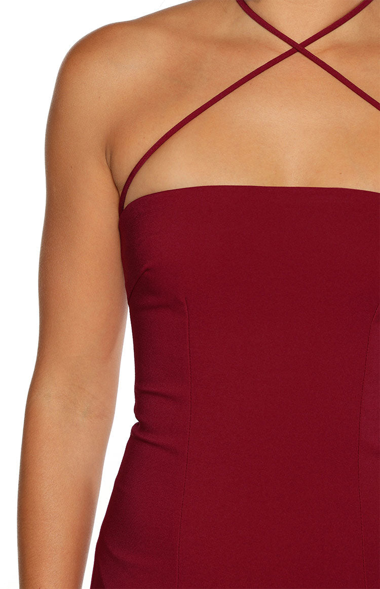 Close-up of the burgundy crepe maxi dress showing the strapless neckline and criss-cross spaghetti straps