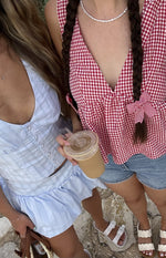 Light blue stripe button front top with a deep V-neckline and cropped fit