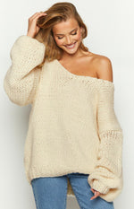Cream chunky knit sweater with an off-shoulder neckline and oversized balloon sleeves
