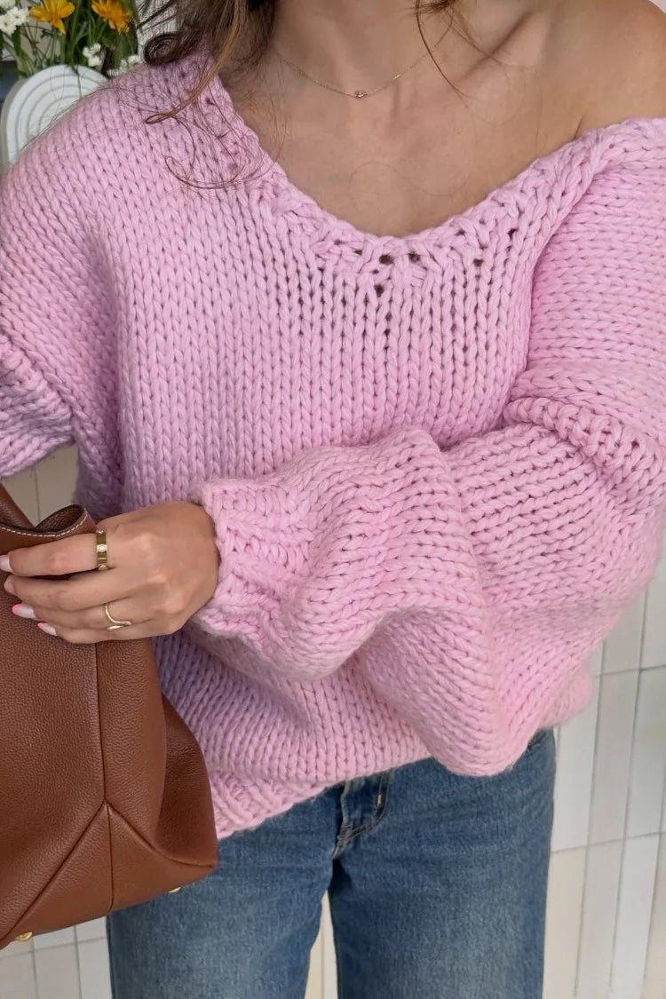 Off-shoulder light pink chunky knit sweater with a relaxed fit and wide long sleeves