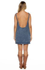 Rear view of a denim mini dress with a deep scoop back and thick straps
