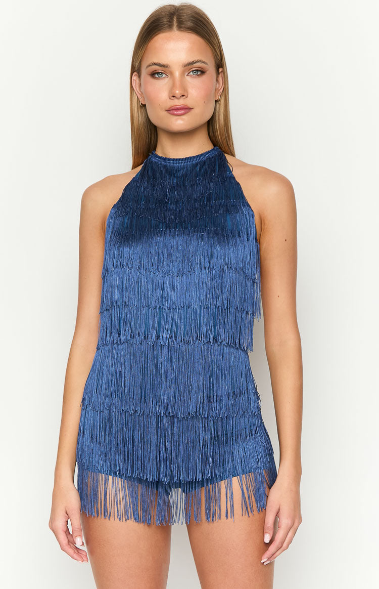 Front view of a blue tassel playsuit with a high halter neckline and dense tiered fringe