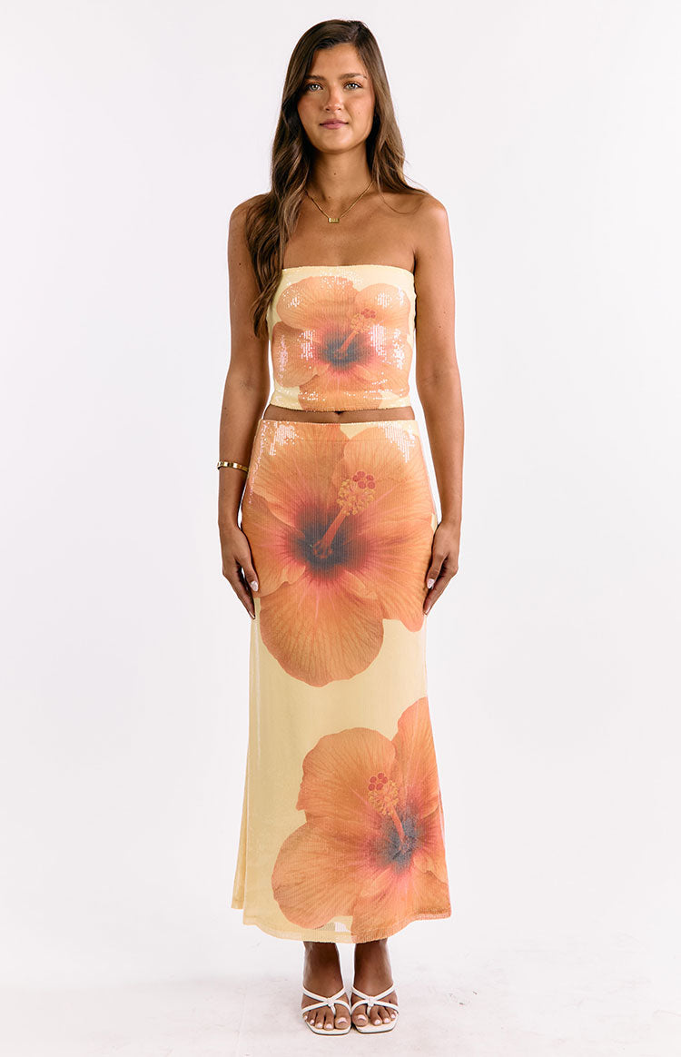 Front view of a yellow sequin strapless crop top with a large orange hibiscus floral print