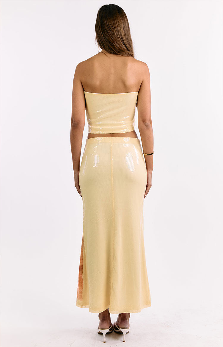 Rear view of a yellow sequin strapless cropped top
