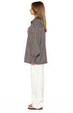 Side view of an oversized brown plaid long sleeve button up shirt with a relaxed fit