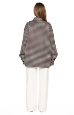 Back view of the brown plaid long sleeve shirt with a relaxed, oversized fit and dropped shoulders