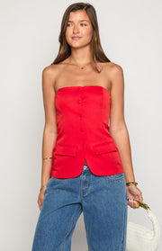 Fitted red strapless top with a button-up front, two flap pockets, and a curved hem