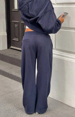 Rear view of navy barrel leg track pants showing the back welt pocket and wide relaxed fit