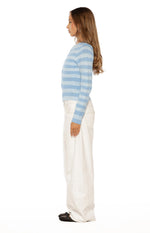 Side view of a blue and white stripe knit sweater with long sleeves and a relaxed, cropped fit