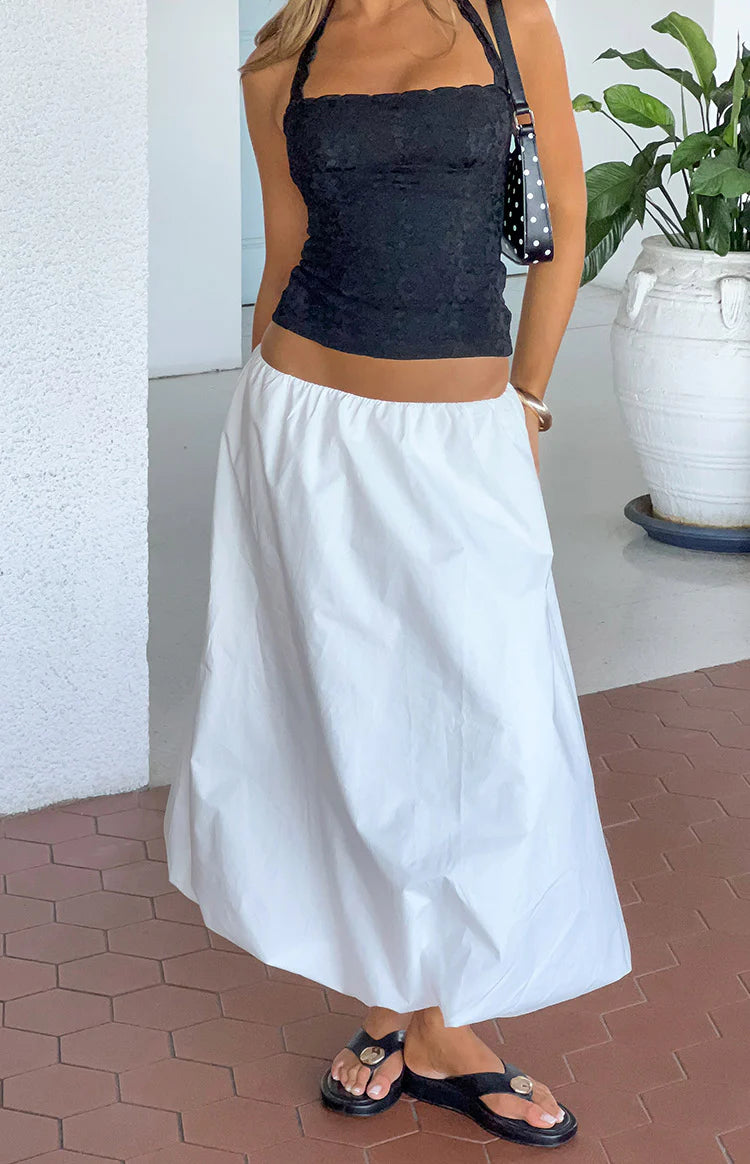White bubble hem skirt with a gathered elastic waist and voluminous, rounded silhouette