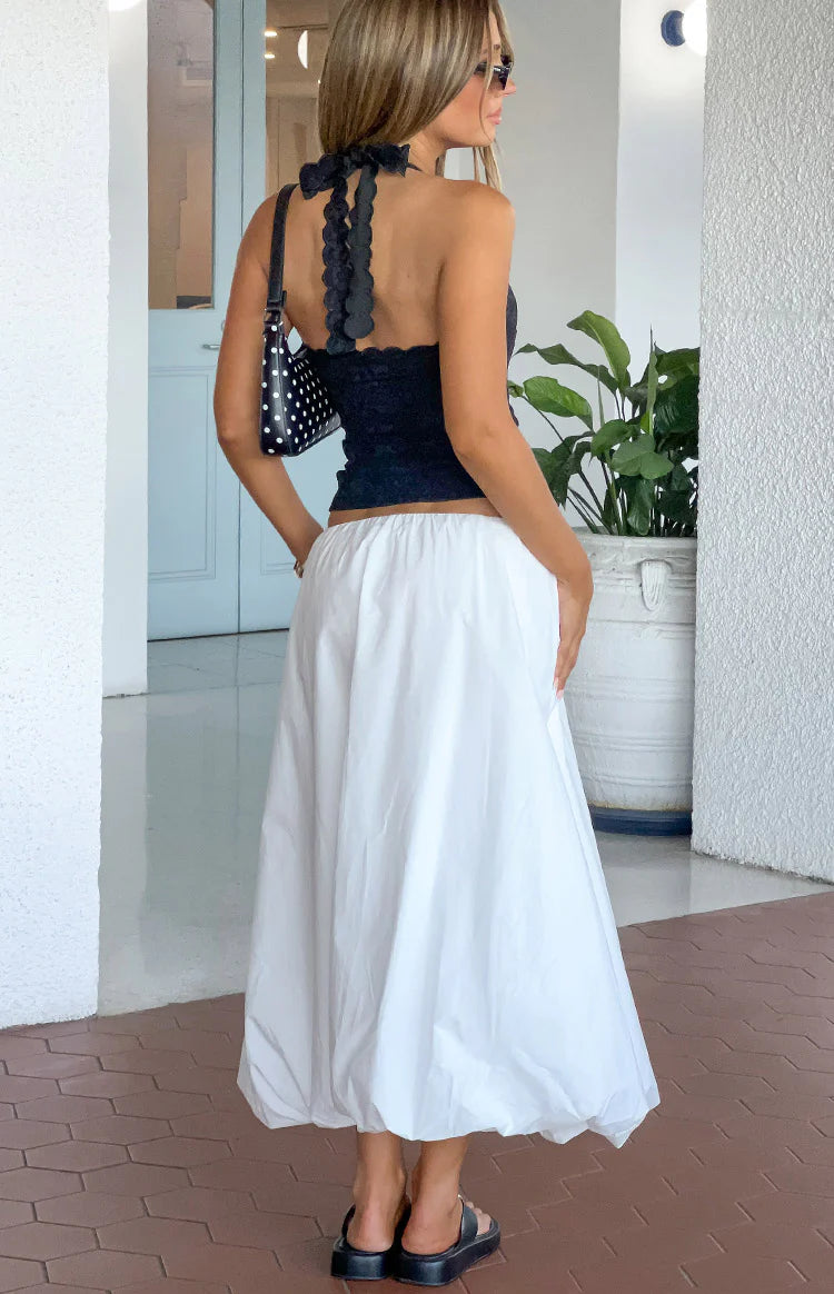 Rear-side view of a white bubble hem skirt with an elasticated waist and voluminous midi length