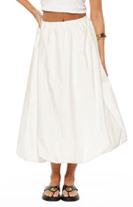 Front view of a white skirt featuring a gathered elasticated waist and a voluminous bubble hem