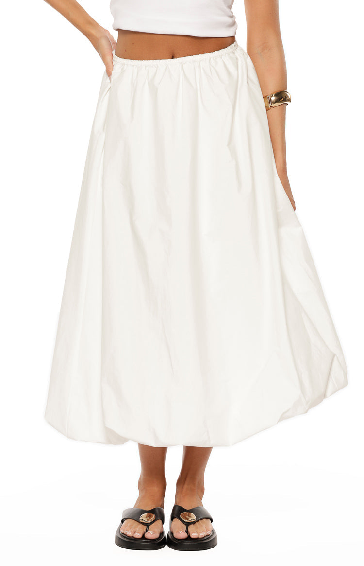 Front view of a white skirt featuring a gathered elasticated waist and a voluminous bubble hem