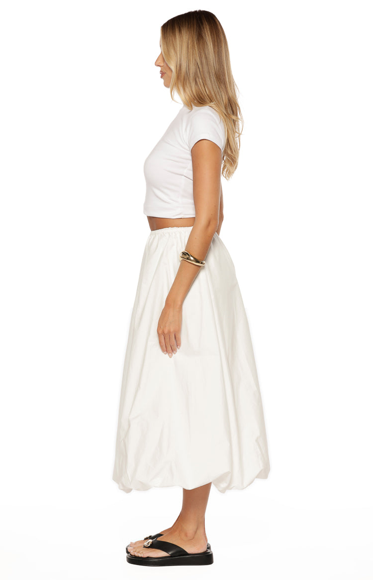 Side view of a white bubble hem skirt with an elasticated waist and voluminous midi length