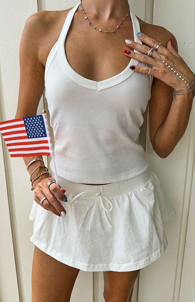 Close-up of the white micro skort with an elasticated drawstring waist and gathered fabric