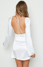 Rear view of a white satin mini dress with a low scoop back, tie-up straps, and long bell sleeves